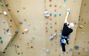 Man climbing up a rock wall.