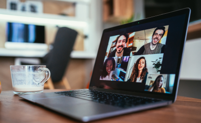 Laptop on table with video conference call happening