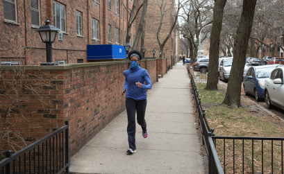 Woman running on city sidewalk