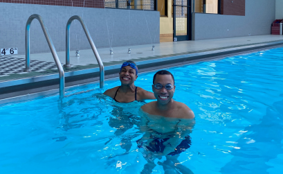 Juan and trainer Joy smiling in the pool